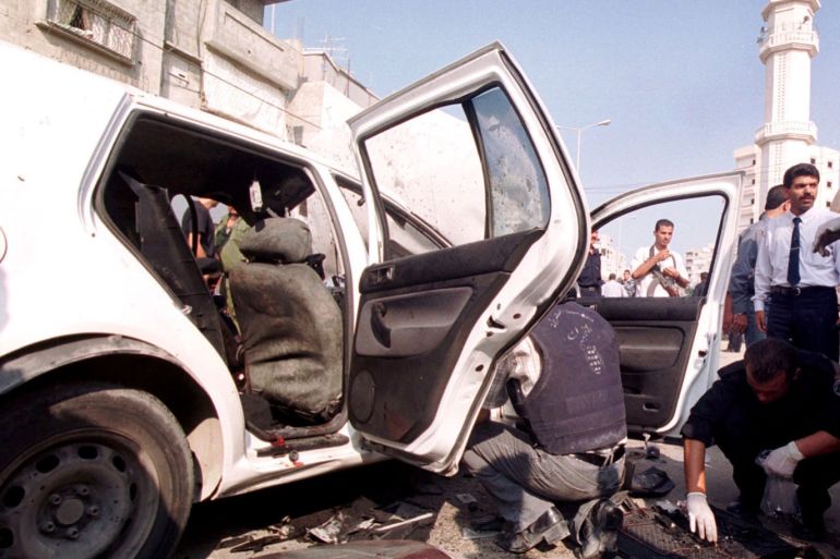 393967 01: Palestinian security officials inspect wreckage following the death of Col. Tayser Khattab, a top aide to the Palestinian intelligence chief, who was was killed in a car explosion September 1, 2001 north of Gaza City. Palestinian officials attributed the bombing to an Israeli assassination. (Photo by John Ali/Getty Images)