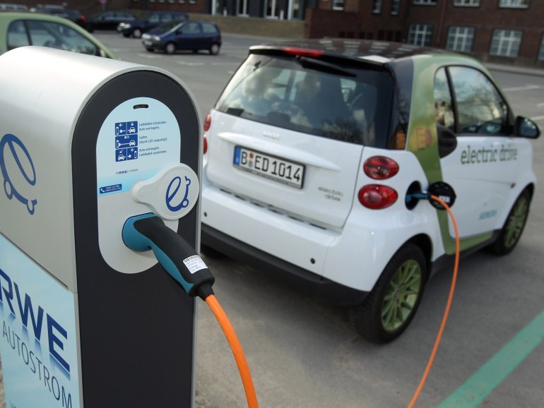 BERLIN - APRIL 01: A company electric Smart car of German engineering company Siemens, at the behest of the photographer, stands attached via a charging cable from a sidewalk-mounted charger on April 1, 2010 in Berlin, Germany. German power producer RWE has erected and is operating over 50 charging columns across Berlin in a pilot project to promote the use of electric cars, and the company is expanding the program across Germany. Siemens is not involved in the project but is running several electric cars from the RWE chargers in Berlin. (Photo by Illustration Sean Gallup/Getty Images)
