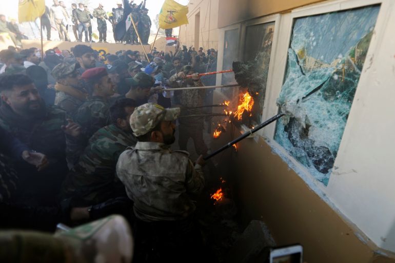 Protesters and militia fighters attack a reception room of the U.S. Embassy, during a protest to condemn air strikes on bases belonging to Hashd al-Shaabi (paramilitary forces), in Baghdad, Iraq December 31, 2019. REUTERS/Khalid al-Mousily