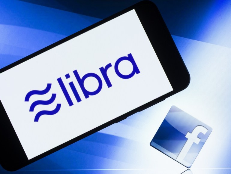 Libra logo- - ANKARA, TURKEY - JULY 12: Screens of a smart phone and a laptop display the logos of Libra and Facebook in Ankara, Turkey on July 12, 2019.