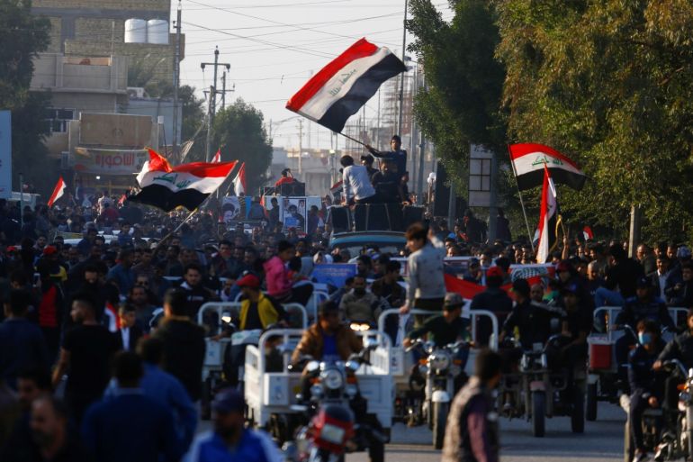 Iraqi demonstrators carry pictures of people who were killed during ongoing anti-government protests in Nassiriya, Iraq December 4, 2019. Picture taken December 4, 2019. REUTERS/Alaa al-Marjani