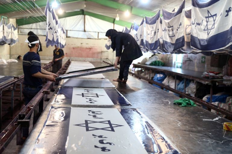 Iranian workers make altered Israeli flags at a large flag factory which creates U.S. and Israeli flags for Iranian protesters to burn in Khomein City, Iran, January 28, 2020. Picture taken January 28, 2020.  Nazanin Tabatabaee/WANA (West Asia News Agency) via REUTERS ATTENTION EDITORS - THIS IMAGE HAS BEEN SUPPLIED BY A THIRD PARTY