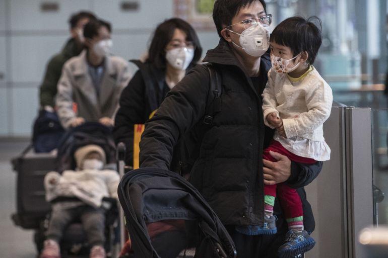 BEIJING, CHINA - JANUARY 30: Passengers wear protective masks as they walk he their luggagein the arrivals area at Beijing Capital Airport on January 30, 2020 in Beijing, China. The number of cases of a deadly new coronavirus rose to over 7000 in mainland China Thursday as the country continued to lock down the city of Wuhan in an effort to contain the spread of the pneumonia-like disease which medicals experts have confirmed can be passed from human to human. In an unprecedented move, Chinese authorities put travel restrictions on the city which is the epicentre of the virus and neighbouring municipalities affecting tens of millions of people. The number of those who have died from the virus in China climbed to over 170 on Thursday, mostly in Hubei province, and cases have been reported in other countries including the United States, Canada, Australia, Japan, South Korea, and France. The World Health Organization has warned all governments to be on alert, and its emergency committee is to meet later on Thursday to decide whether to declare a global health emergency. (Photo by Kevin Frayer/Getty Images)
