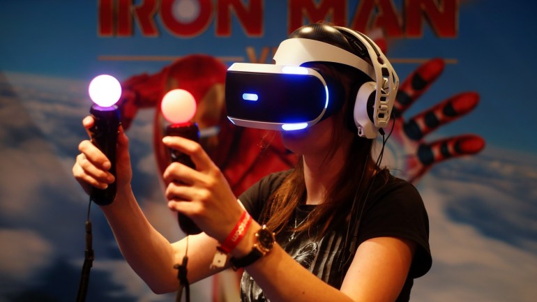 A gamer plays on a Playstation VR with virtual reality goggles and two controllers that look like regular bulbs during the first day of Europe's leading digital games fair Gamescom, which showcases the latest trends of the computer gaming scene in Cologne, Germany, August 21, 2019. REUTERS/Wolfgang Rattay