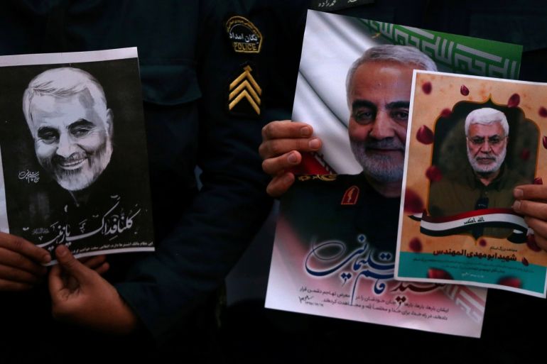 Iranian guards hold a picture of the late Iranian Major-General Qassem Soleimani, during a protest against the killing of Soleimani, head of the elite Quds Force, and Iraqi militia commander Abu Mahdi al-Muhandis, who were killed in an air strike at Baghdad airport, in front of United Nation office in Tehran, Iran January 3, 2020. WANA (West Asia News Agency)/Nazanin Tabatabaee via REUTERS ATTENTION EDITORS - THIS IMAGE HAS BEEN SUPPLIED BY A THIRD PARTY.
