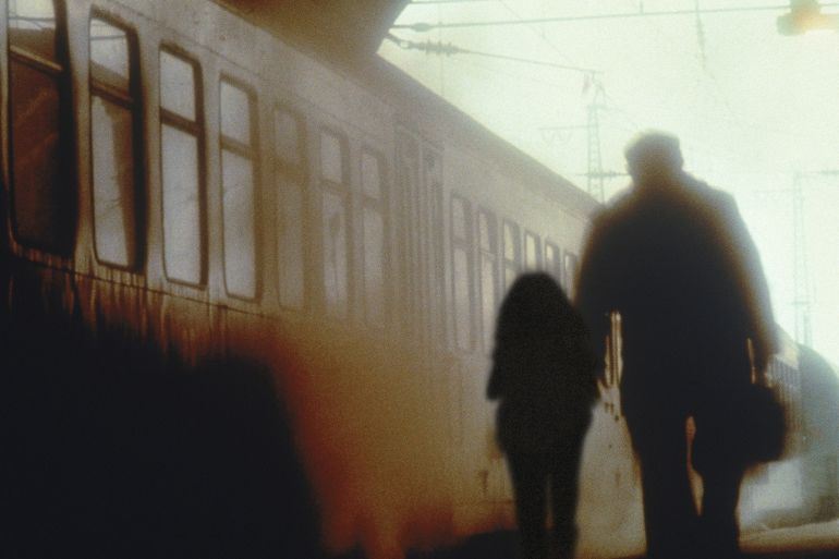 صورة تعبيرية لأب وابنته الصغيرة بجانب قطار