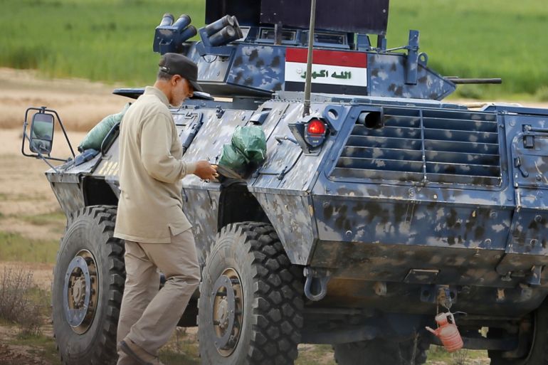 Iranian Revolutionary Guard Commander Qassem Soleimani walks near an armoured vehicle at the frontline during offensive operations against Islamic State militants in the town of Tal Ksaiba in Salahuddin province March 8, 2015. Picture taken March 8, 2015. REUTERS/Stringer (IRAQ - Tags: CIVIL UNREST CONFLICT POLITICS)