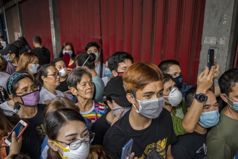 MANILA, PHILIPPINES - JANUARY 31: Filipinos hoping to buy face masks crowd outside a medical supply shop that was raided by police for allegedly hoarding and overpricing the masks, as public fear over China's Wuhan Coronavirus grows, on January 31, 2020 in Manila, Philippines. The Philippine government has been heavily criticized after failing to immediately implement travel restrictions from China, the source of a deadly coronavirus that has now killed hundreds and infected thousands more. The World Health Organization (WHO) on Thursday declared the coronavirus a public health emergency of international concern. (Photo by Ezra Acayan/Getty Images)
