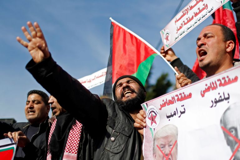 A Palestinian demonstrator gestures as another holds a banner showing crossed-out pictures depicting U.S. President Donald Trump and Arthur Balfour during a protest against the U.S. Middle East peace plan, in Gaza City January 27, 2020. REUTERS/Mohammed Salem