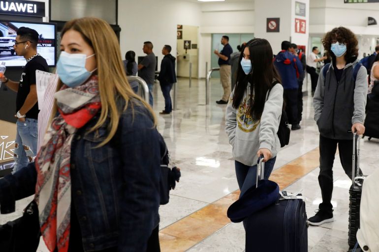People wear protective face masks at Benito Juarez International Airport after Mexico's government said on Friday it had detected the country's first cases of coronavirus infection, in Mexico City, Mexico February 28, 2020. REUTERS/Carlos Jasso