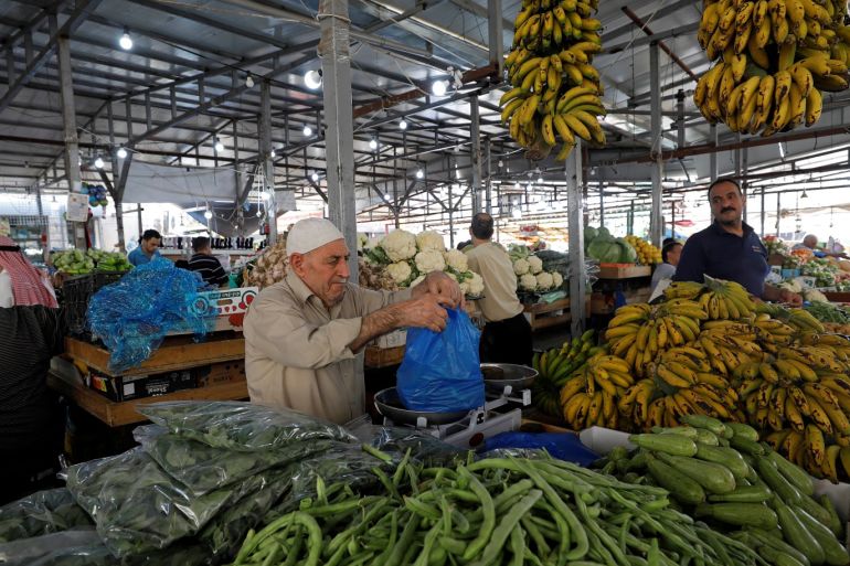 A Palestinian man sells vegetables in a market in Ramallah in the Israeli-occupied West Bank May 21, 2019. REUTERS/Mohamad Torokman