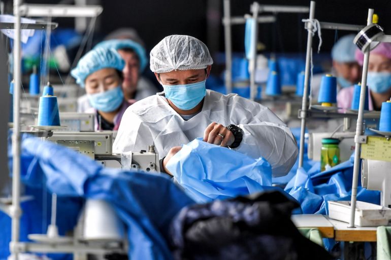Workers make protective suits at a factory of a medical equipment maker in Urumqi, Xinjiang Uighur Autonomous Region, China January 27, 2020. Picture taken January 27, 2020. cnsphoto via REUTERS. ATTENTION EDITORS - THIS IMAGE WAS PROVIDED BY A THIRD PARTY. CHINA OUT.