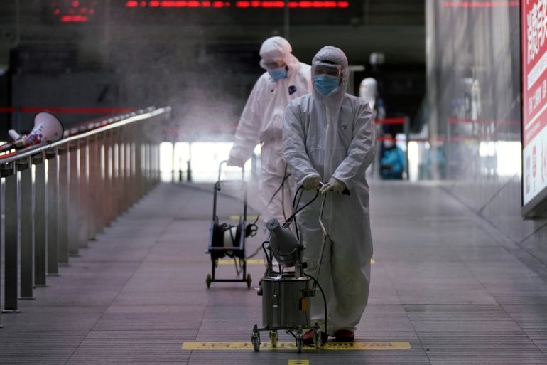 Workers with sanitizing equipment disinfect at the Shanghai railway station in Shanghai, China, as the country is hit by an outbreak of a new coronavirus, February 27, 2020. REUTERS/Aly Song