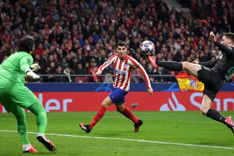 MADRID, SPAIN - FEBRUARY 18: Alvaro Morata of Atletico Madrid looks on as Andy Robertson of Liverpool clears the ball during the UEFA Champions League round of 16 first leg match between Atletico Madrid and Liverpool FC at Wanda Metropolitano on February 18, 2020 in Madrid, Spain. (Photo by Michael Regan/Getty Images)