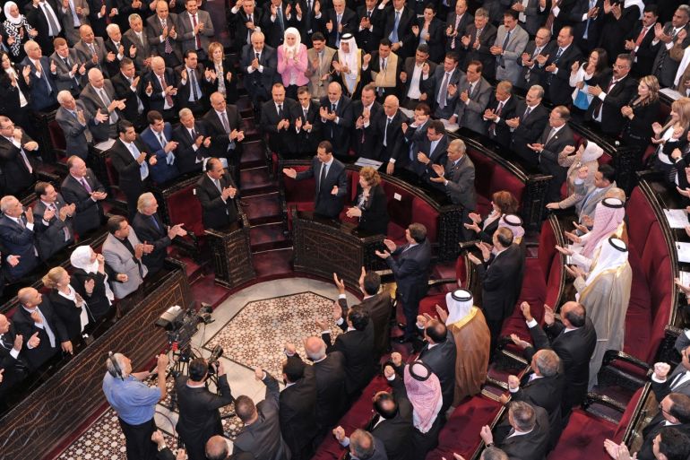 Syria's president Bashar al-Assad(C) gestures while parliament members clap in Damascus, Syria in this handout picture provided by SANA on June 7, 2016. SANA/Handout via ATTENTION EDITORS - THIS PICTURE WAS PROVIDED BY A THIRD PARTY. REUTERS IS UNABLE TO INDEPENDENTLY VERIFY THE AUTHENTICITY, CONTENT, LOCATION OR DATE OF THIS IMAGE. FOR EDITORIAL USE ONLY.