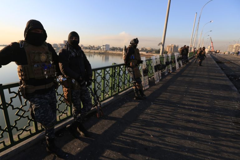 Baghdad removes concrete barriers - - BAGHDAD, IRAQ - FEBRUARY 12: Security officials take measurements as concrete blocks are being removed from a bridge to reopen streets which were closed due to anti government protests, in Baghdad, Iraq on February 12, 2020.