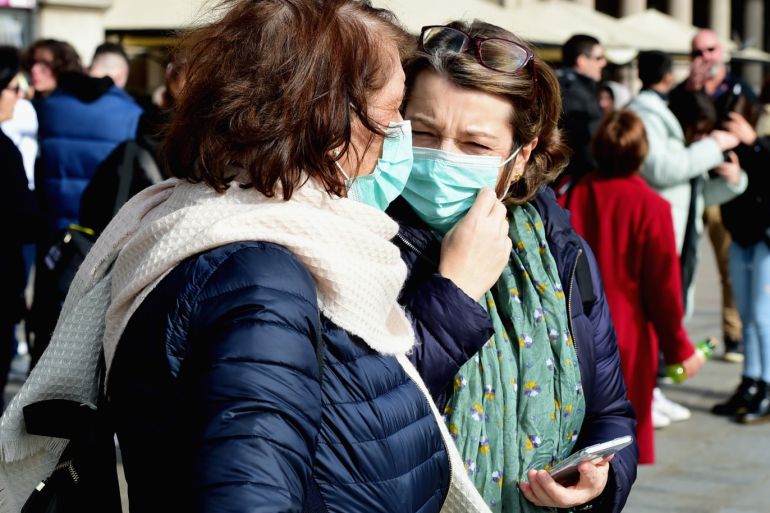 Coronavirus precautions in Italy- - MILAN, ITALY - FEBRUARY 23: Women wearing respiratory masks are seen on February 23, 2020 in Milan, Italy. The Lombardy is one of the most affected region in Italy by the infection of the Coronavirus COVID-19 virus.
