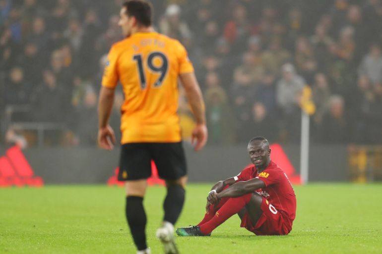WOLVERHAMPTON, ENGLAND - JANUARY 23: Sadio Mane of Liverpool sits on the turf before being substituted during the Premier League match between Wolverhampton Wanderers and Liverpool FC at Molineux on January 23, 2020 in Wolverhampton, United Kingdom. (Photo by Catherine Ivill/Getty Images)