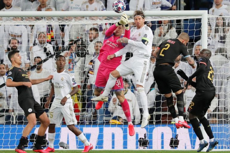 Soccer Football - Champions League - Round of 16 First Leg - Real Madrid v Manchester City - Santiago Bernabeu, Madrid, Spain - February 26, 2020 Manchester City's Ederson in action with Real Madrid's Sergio Ramos REUTERS/Susana Vera