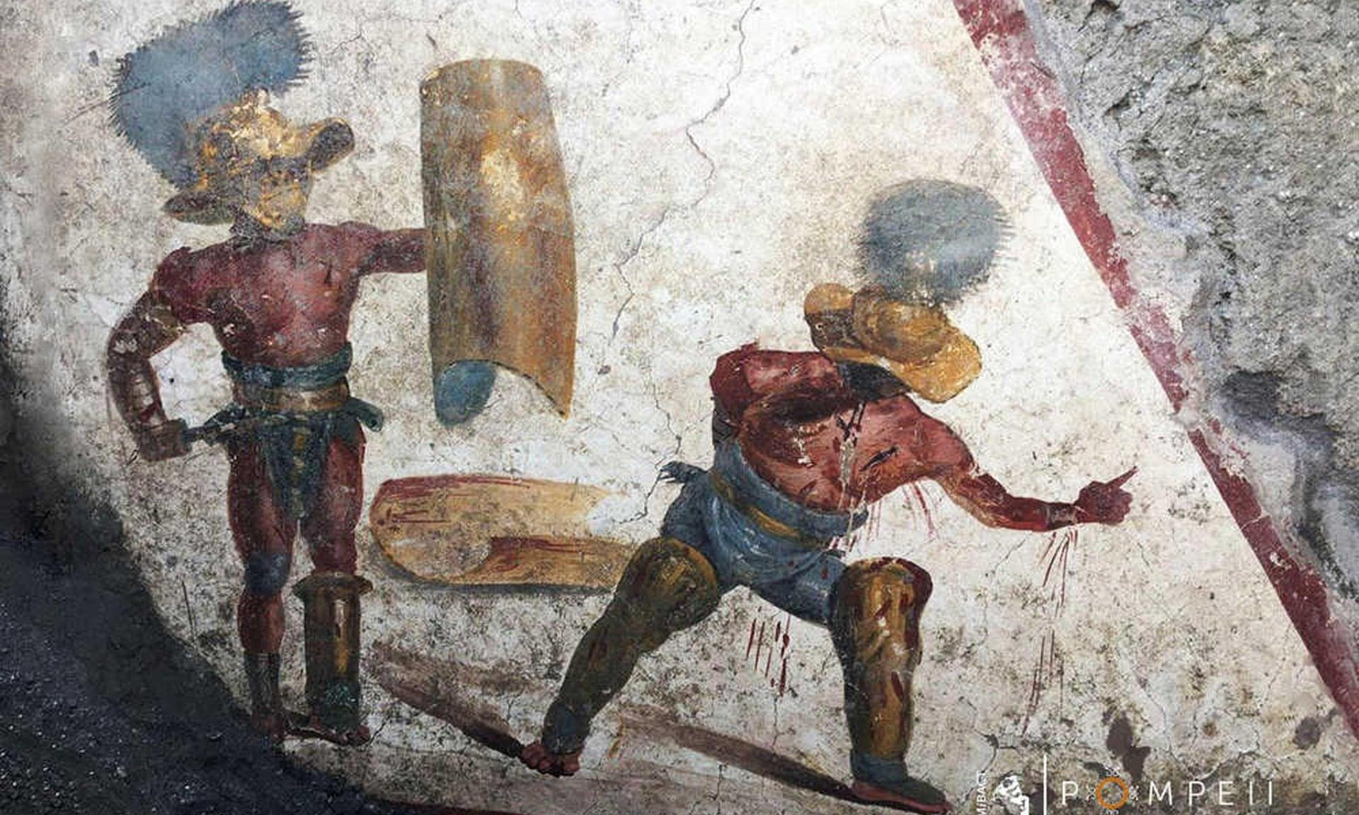 جدارية في بومبي تُصوِّر اثنين من المتصارعين في حلبة القتال (مواقع التواصل)