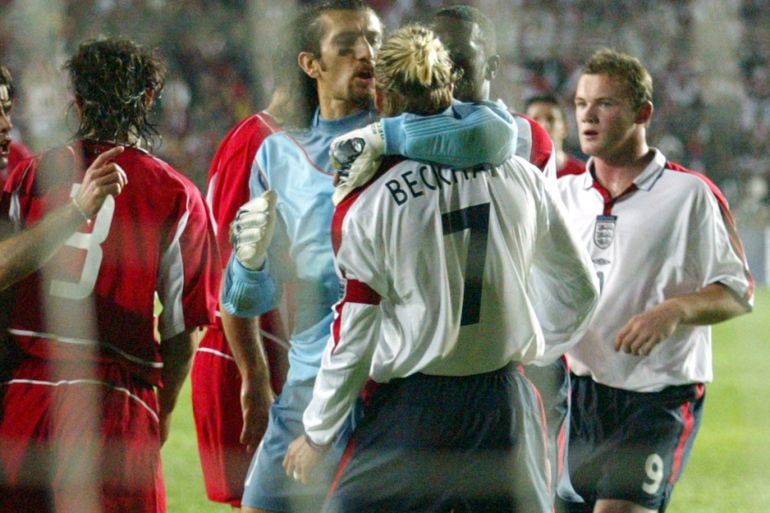 ENGLAND'S CAPTAIN DAVID BECKHAM IS HELD BY TURKEY'S KEEPER RUSTU RECBERDURING ENGLAND'S GROUP 7 EURO 2004 QUALIFYING MATCH AGAINST TURKEY INISTANBUL.