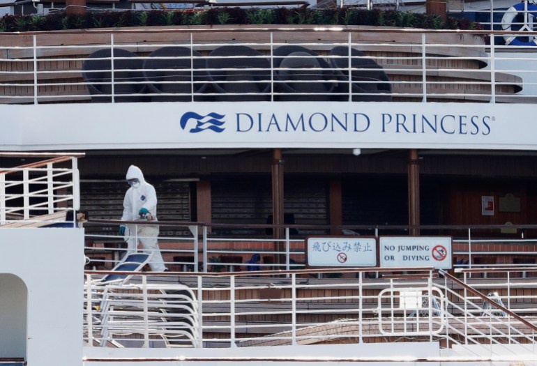 A worker in protective gear is seen on the cruise ship Diamond Princess seen at Daikoku Pier Cruise Terminal in Yokohama, south of Tokyo, Japan