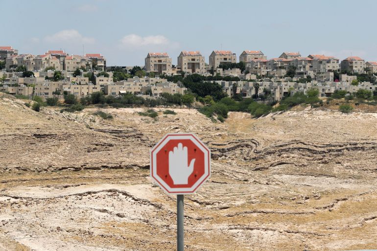 Traffic sign is pictured in front of the Israeli settlement of Maale Adumim in the Israeli-occupied West Bank