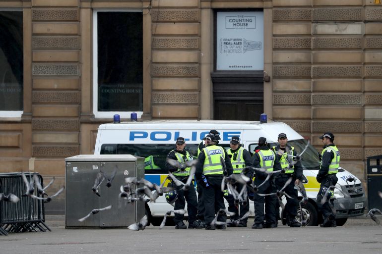 Police officers are seen at George Square in Glasgow