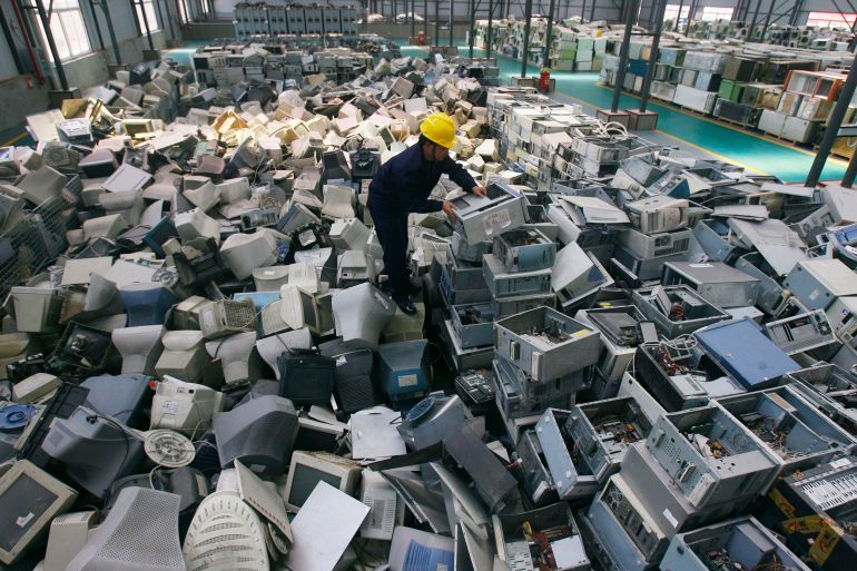 An employee arranges discarded computers at a newly opened electronic waste recycling factory in Wuhan