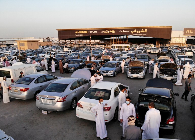 People gather to buy cars before the expected increase of VAT to 15% in Riyadh