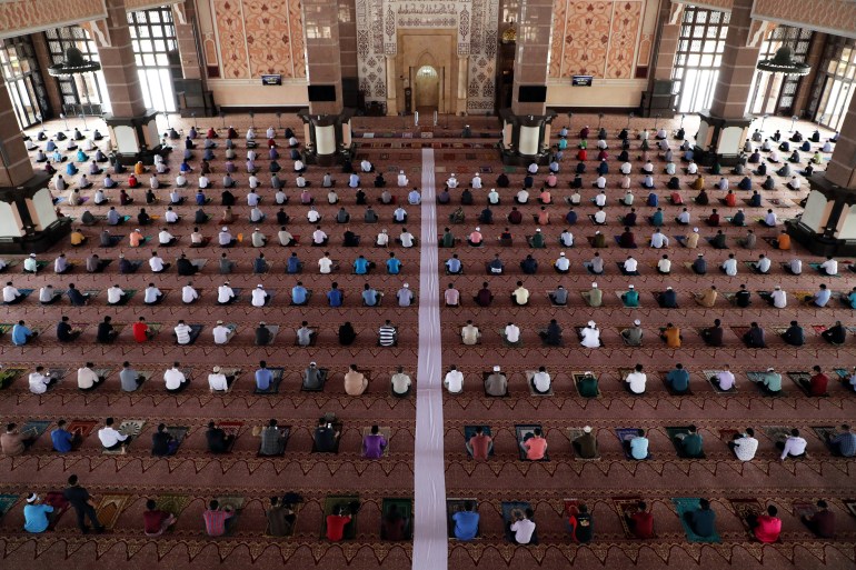 Muslims following social distancing measures pray inside a mosque, amid the coronavirus disease (COVID-19) outbreak in Putrajaya