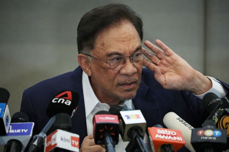 Malaysia opposition leader Anwar Ibrahim reacts during a news conference in Kuala Lumpur