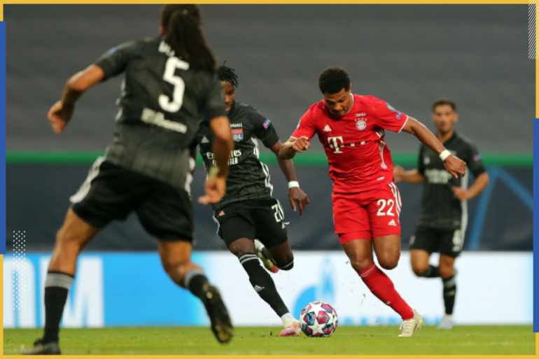 LISBON, PORTUGAL - AUGUST 19: Serge Gnabry of Bayern Munich takes on Karl Toko Ekambi of Olympique Lyonnais before scoring his team's first goal during the UEFA Champions League Semi Final match between Olympique Lyonnais and Bayern Munich at Estadio Jose Alvalade on August 19, 2020 in Lisbon, Portugal. (Photo by Miguel A. Lopes/Pool via Getty Images)