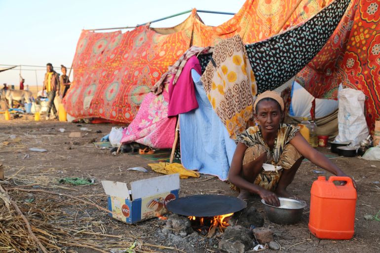 An Ethiopian who fled the ongoing fighting in Tigray region, prepares a meal before being processed for emergency food and logistics support by the World Food Program in Hamdait village on the Sudan-Ethiopia border in eastern Kassala state, Sudan November 17, 2020. Picture taken November 17, 2020. World Food Program/Handout via REUTERS THIS IMAGE HAS BEEN SUPPLIED BY A THIRD PARTY. NO RESALES. NO ARCHIVES