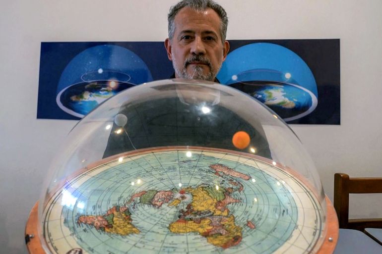 BRAZIL-SCIENCE-FLAT-EARTH-NEVES Brazilian self-avowed flat-Earth conspiracy theorist Anderson Neves holds a model of the flat earth surrounded by a dome during an interview with AFP in Sao Paulo, Brazil, on February 13, 2020. Eleven million people in Brazil, 7% of its population, believe that the Earth is flat, according to Datafolha polling institute.
