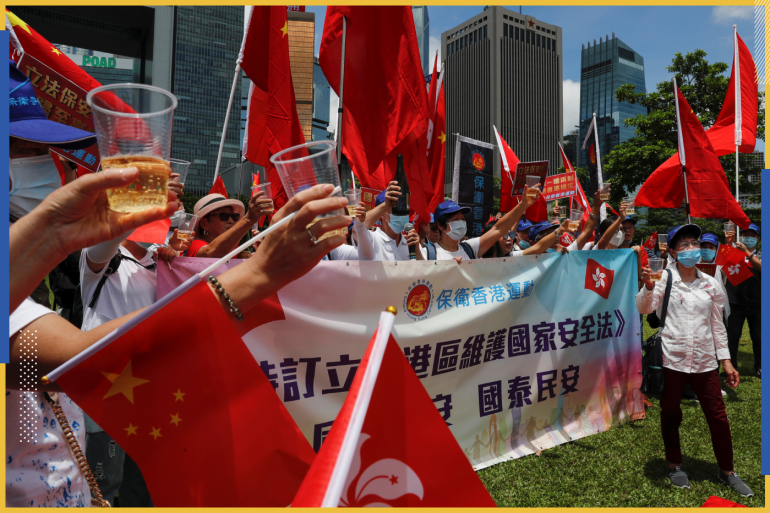 Pro-China supporters celebrate with champagne after China's parliament passes national security law for Hong Kong, in Hong Kong, China June 30, 2020. REUTERS/Tyrone Siu