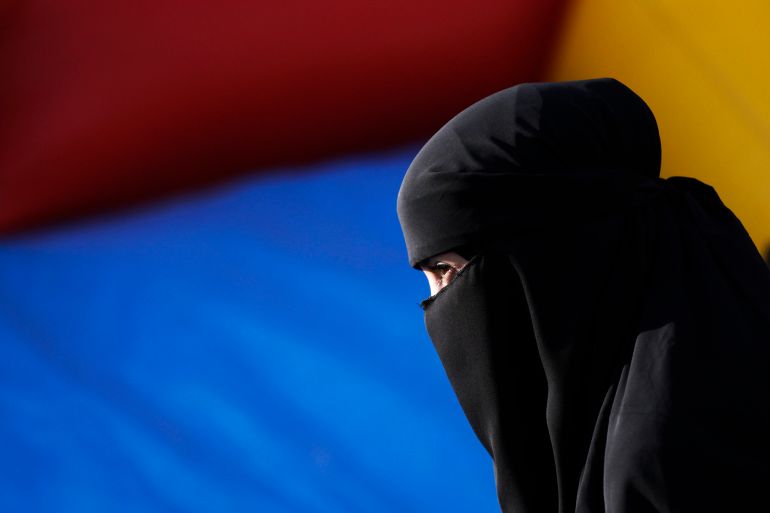 A Muslim woman wearing a niqab attends a protest against islamophobia and racism organized by the Islamic Central Council of Switzerland in Bern