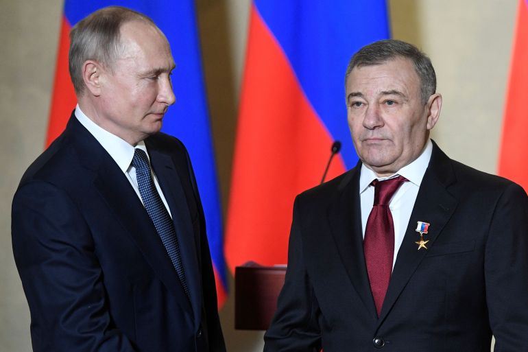 Russian President Vladimir Putin and businessman Arkady Rotenberg attend an awarding ceremony in Sevastopol
