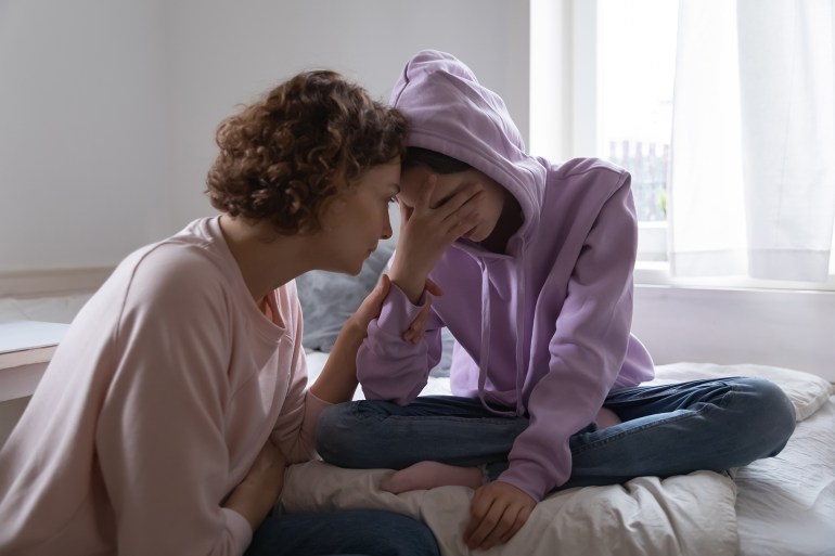Worried parent young mom comforting depressed crying teen daughter bonding at home. Loving understanding mother apologizing or supporting sad teenage girl having psychological puberty problem concept.; Shutterstock ID 1701862456; Department: -