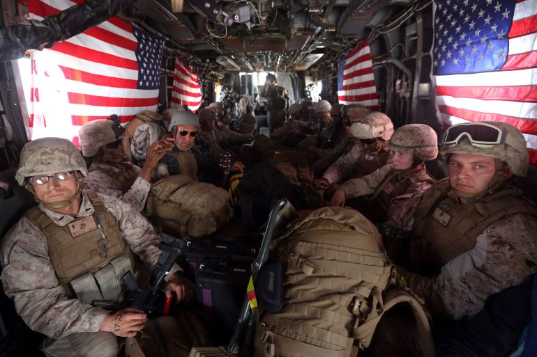 U.S. Marines are seen on board a helicopter at Kandahar air base upon the end of operations for the Marines and British combat troops in Helmand