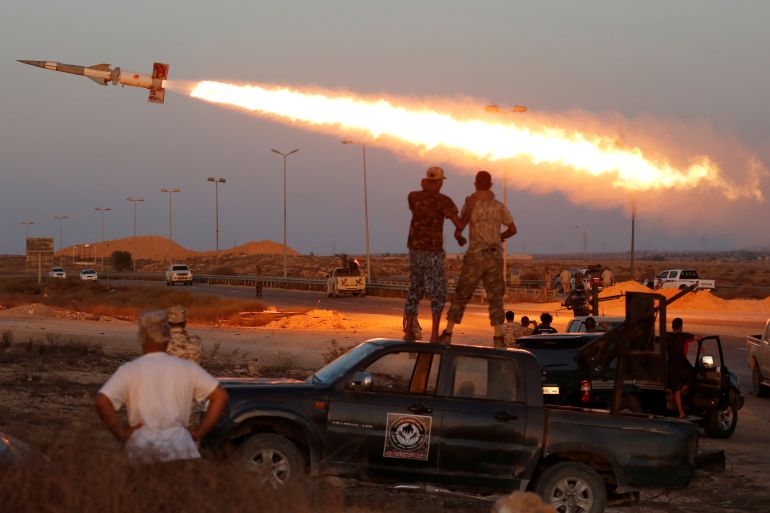 Fighters of Libyan forces allied with the U.N.-backed government fire a rocket at Islamic State fighters in Sirte, Libya