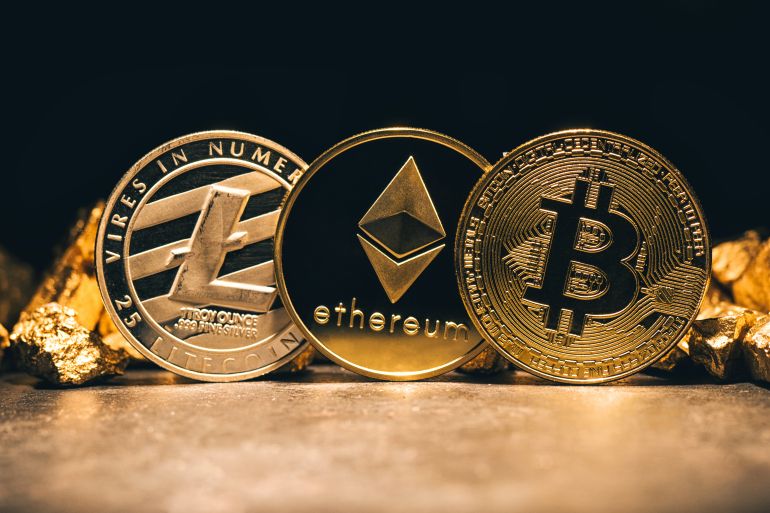 Golden cryptocurrencys Bitcoin, Ethereum, Litecoin and mound of gold - Business concept image; Shutterstock ID 770928178; Department: -