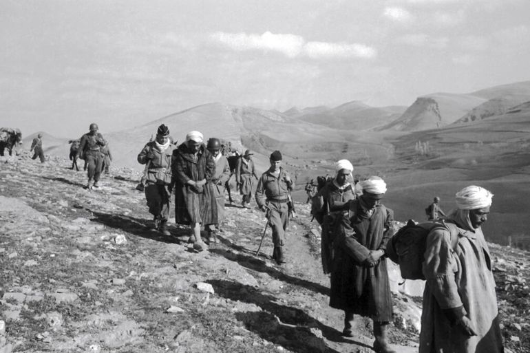 French soldiers marching with Algerian prisoners in 1956. The French colonial past in Algeria is a trauma that continues to shape modern France.Credit...Reporters Associes/Gamma-Rapho, via Getty Image