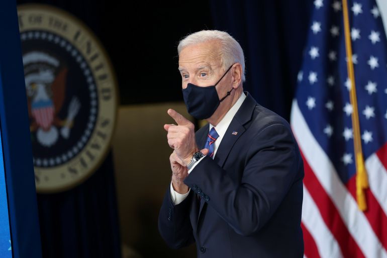 U.S. President Joe Biden returns to the podium for his mask after signing an Equal Pay Day for women proclamation at the White House in Washington, U.S. March 24, 2021. REUTERS/Jonathan Ernst
