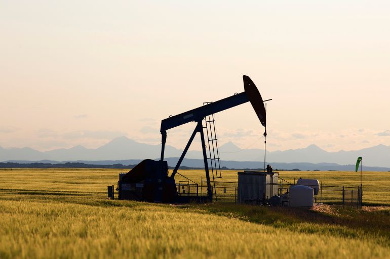 An oil pump jack pumps oil in a field near Calgary
