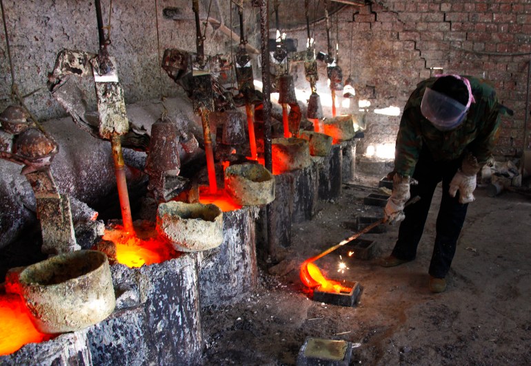 Ren, a worker at the Jinyuan Company's smelting workshop, pours the rare earth metal Lanthanum into a mould near the town of Damao, located in China's Inner Mongolia Autonomous Region