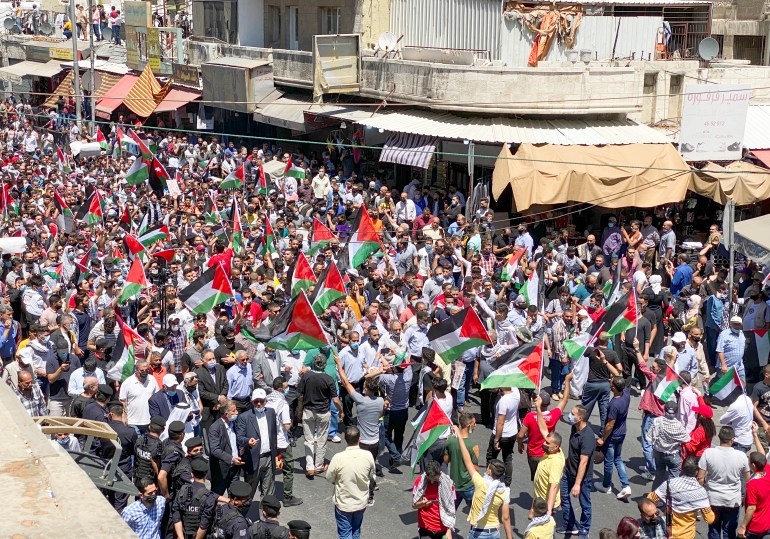 Demonstrators take part in a protest to express solidarity with the Palestinian people, in downtown Amman
