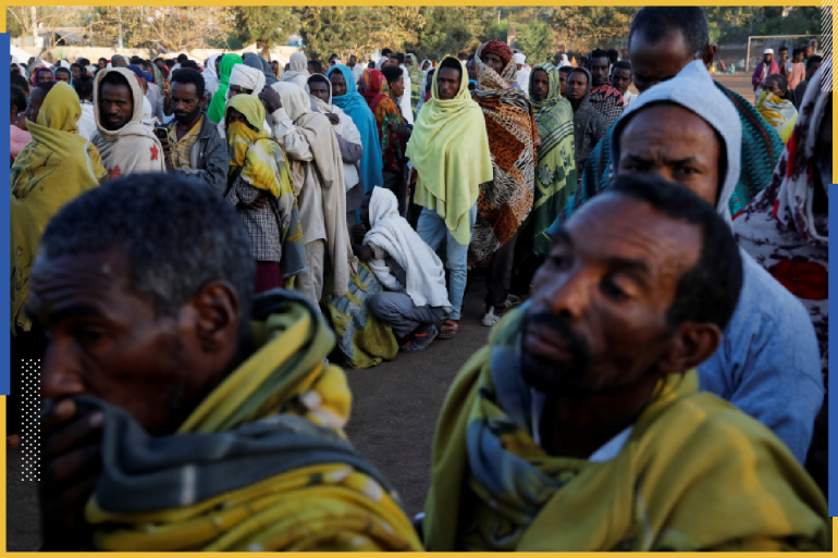 Displaced people queue for food at the Tsehaye primary school, which was turned into a temporary shelter for people displaced by conflict, in the town of Shire, Tigray region, Ethiopia, March 15, 2021. REUTERS/Baz Ratner SEARCH "RATNER TIGRAY" FOR THIS STORY. SEARCH "WIDER IMAGE" FOR ALL STORIES