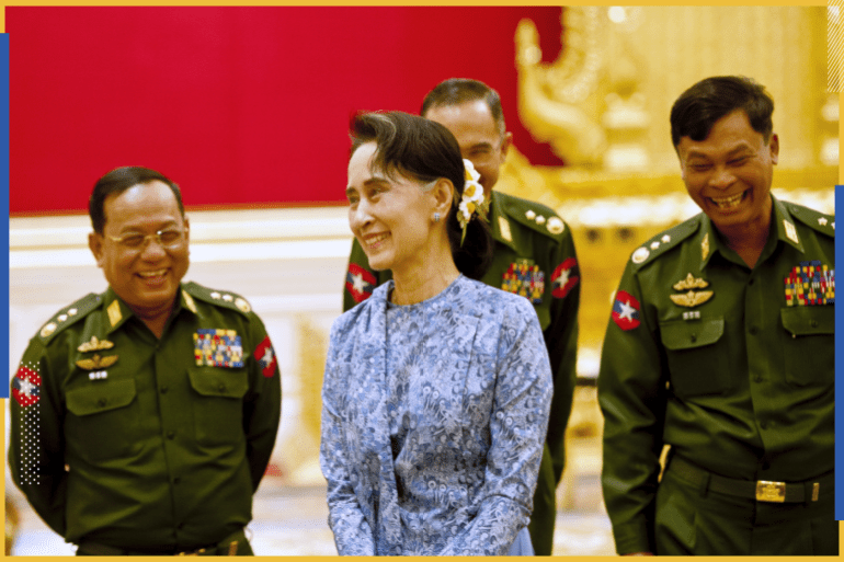 Myanmar's NLD party leader Aung San Suu Kyi smiles with army members during the handover ceremony of outgoing President Thein Sein and new President Htin Kyaw at the presidential palace in Naypyitaw March 30, 2016. REUTERS/Ye Aung Thu/Pool TPX IMAGES OF THE DAY