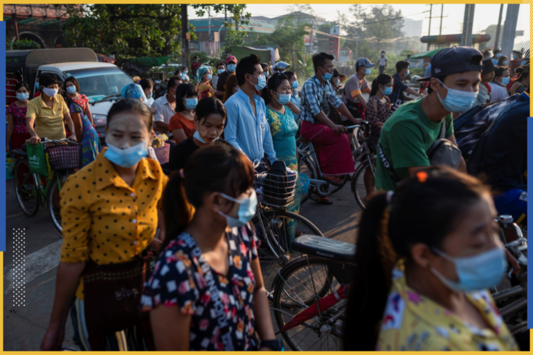 Pedestrians wearing protective face masks walk on a street,?amid the outbreak of the coronavirus disease (COVID-19), in Yangon, Myanmar, December 7, 2020.?Picture taken December 7, 2020. REUTERS/Shwe Paw Mya Tin